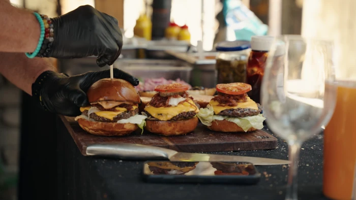 Fresh meat patties cooking on the grill