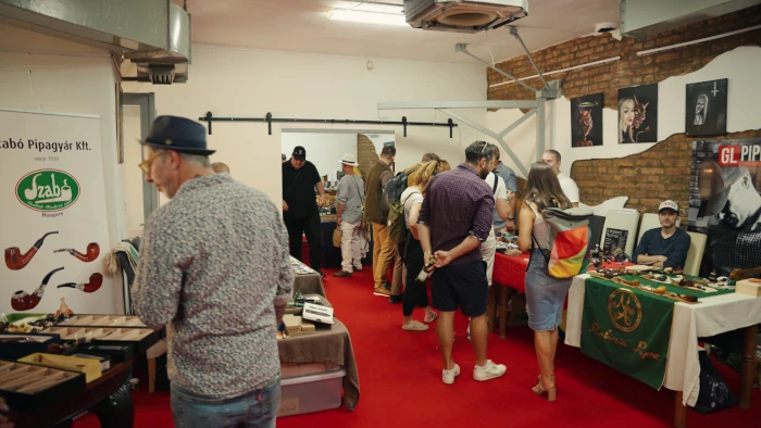 Spacious exhibition hall filled with visitors and exhibitor tables