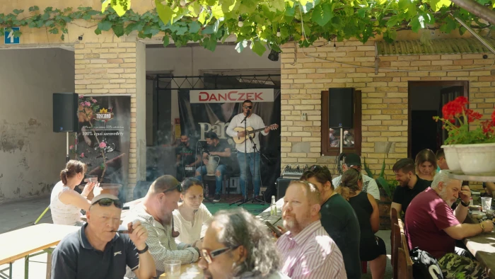 Atmospheric garden area with tables, musicians in the background
